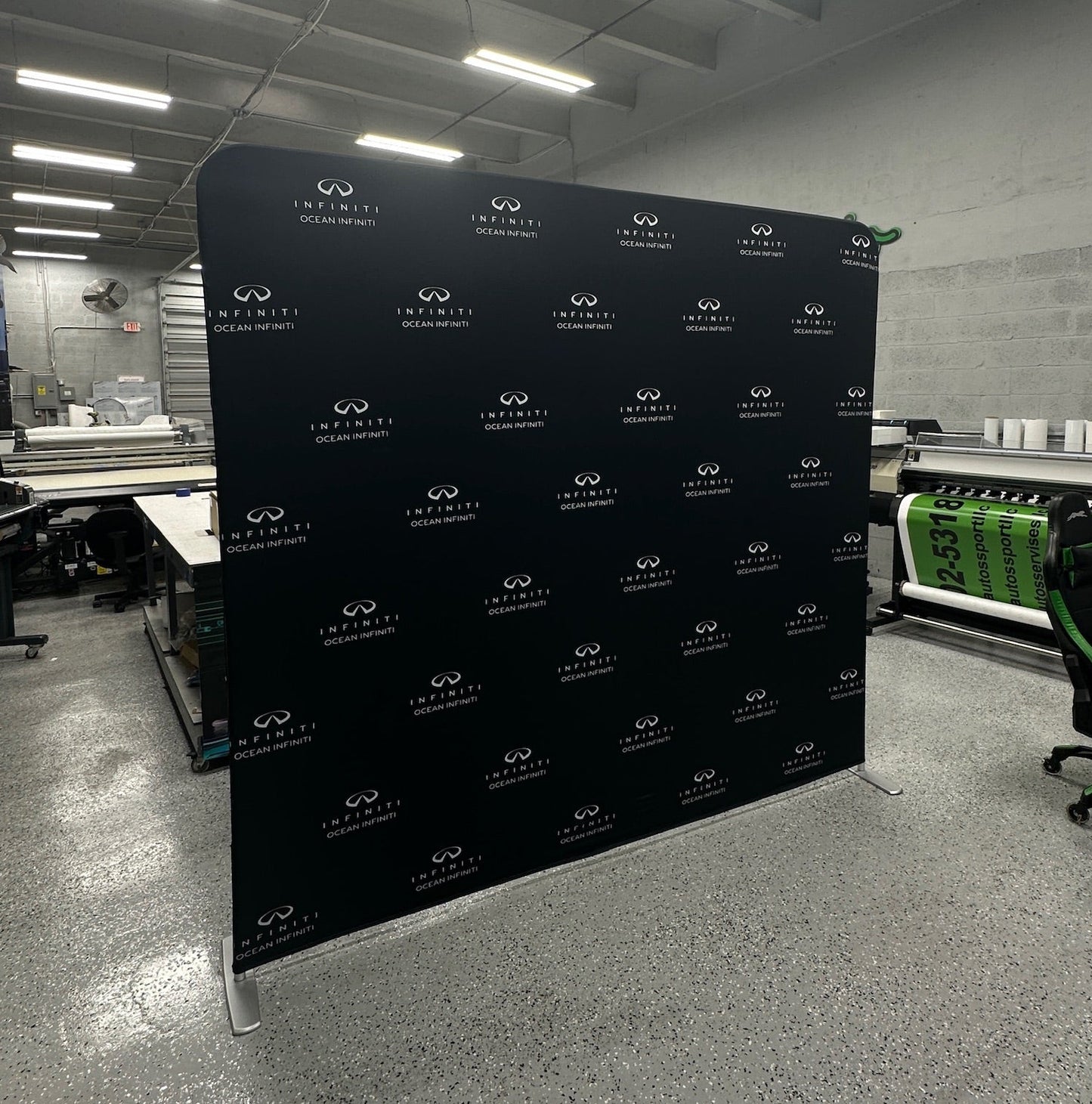 Black backdrop with white logos in a warehouse setting