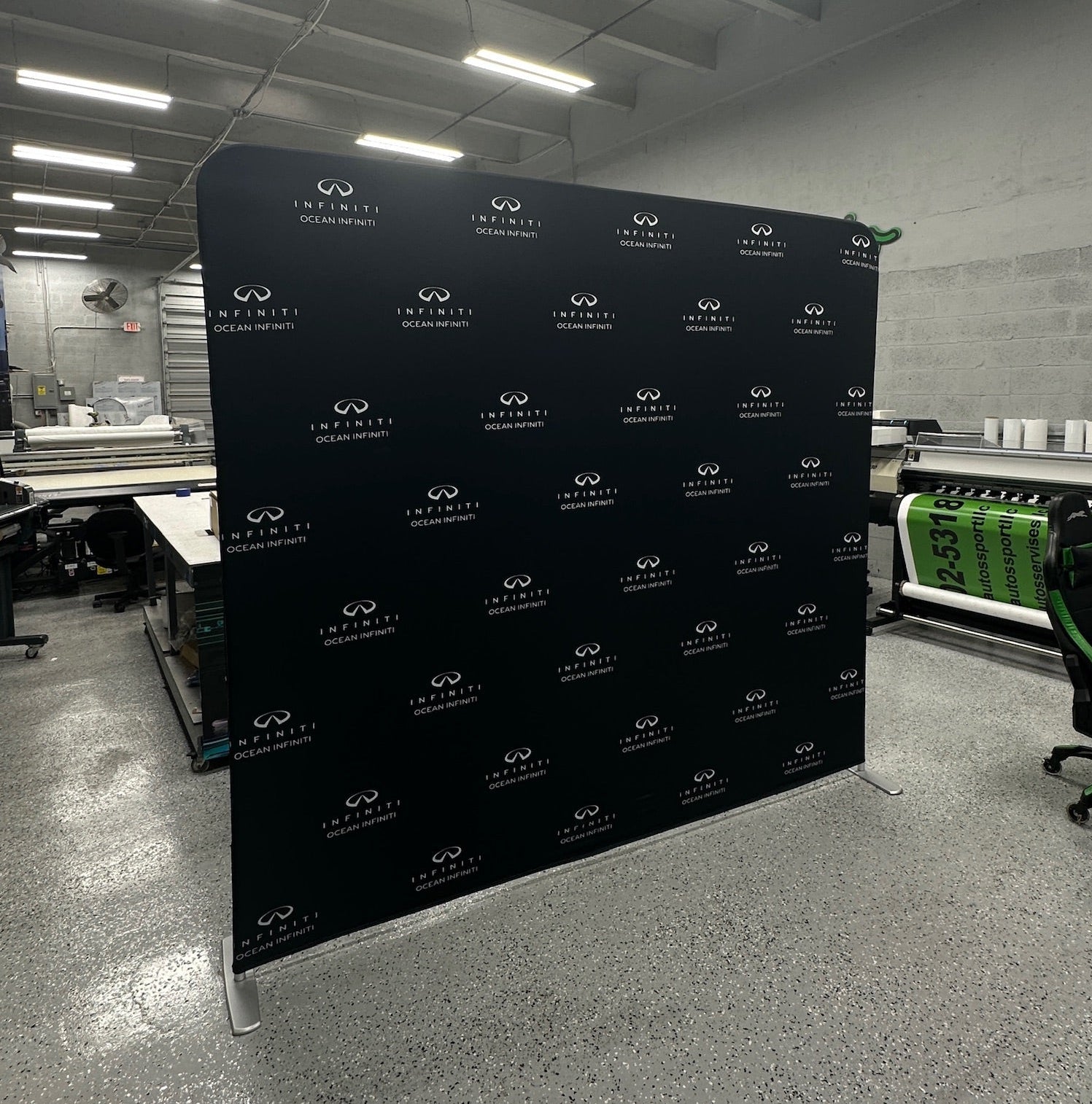 Black backdrop with white logos in a warehouse setting